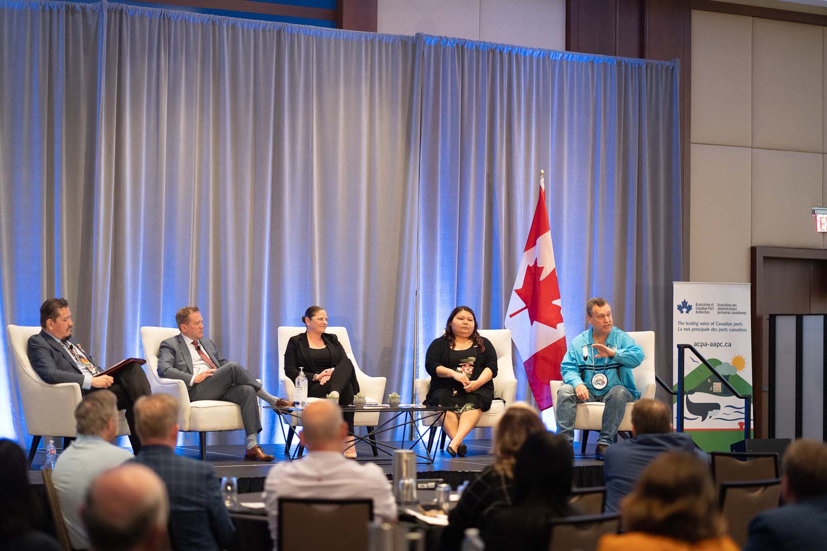 Presenters on stage with Canadian flag