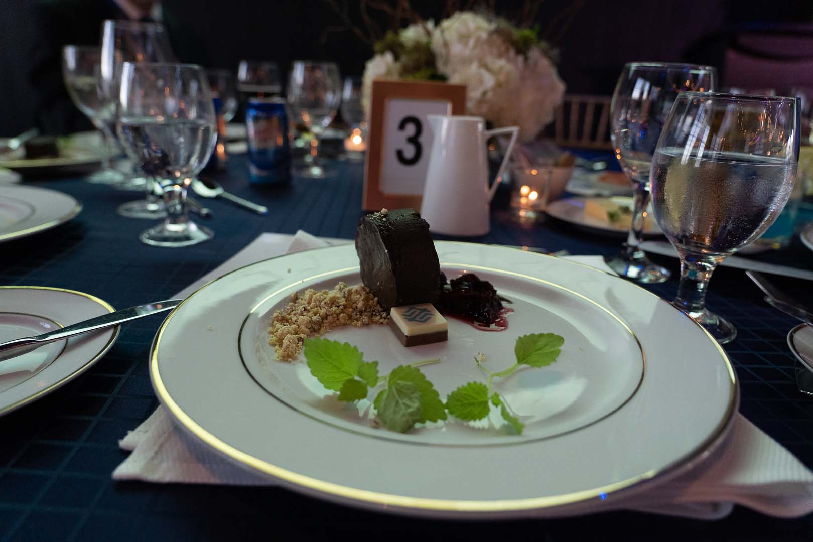 dinner plate and water glasses on reserved table